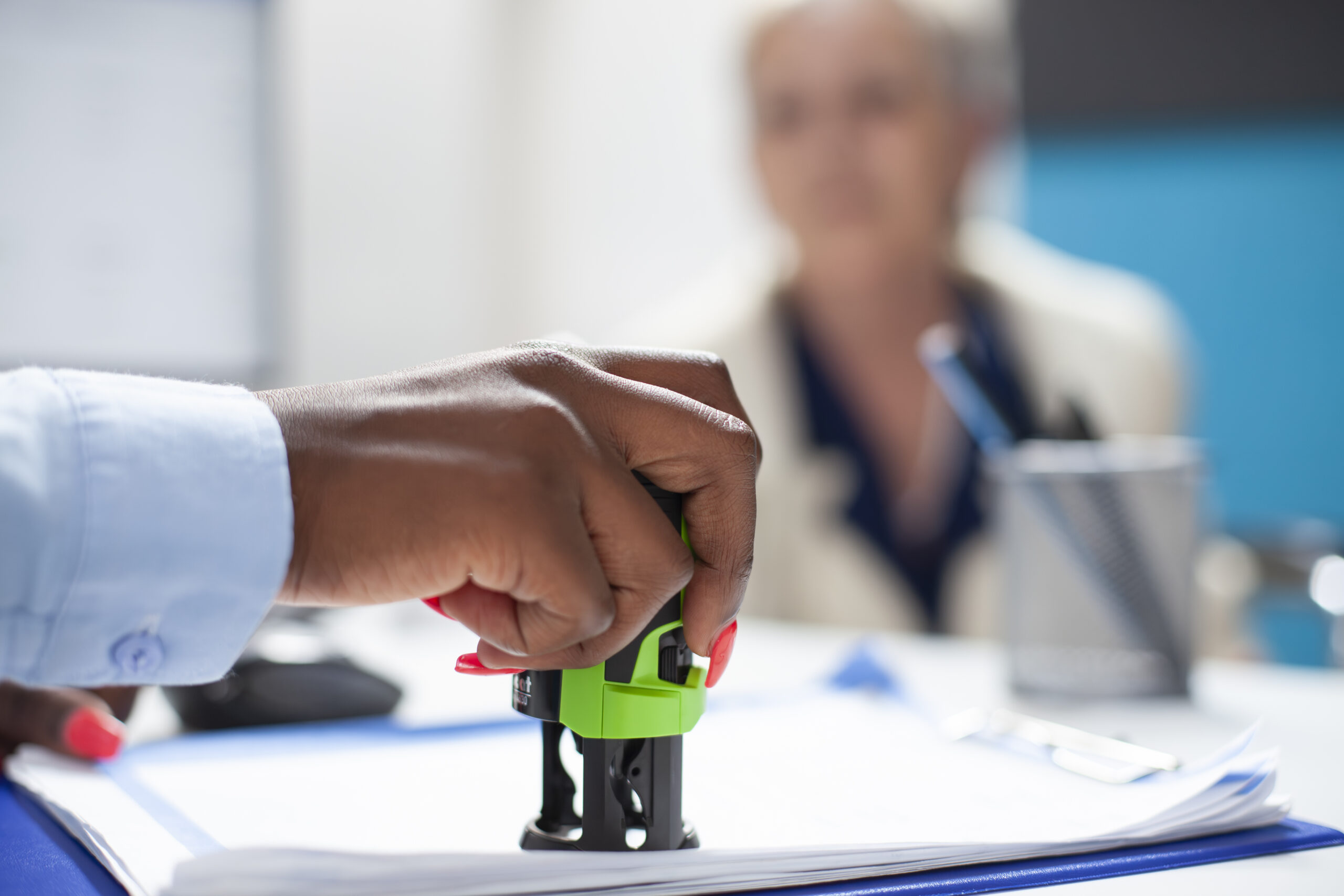 Doctor putting medical stamp on document
